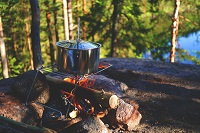 Large Outdoor Cooking pot over outside campfire.